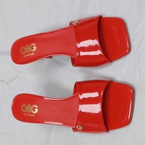 Red 3 inch spike heel no back with a fake diamond on shoe